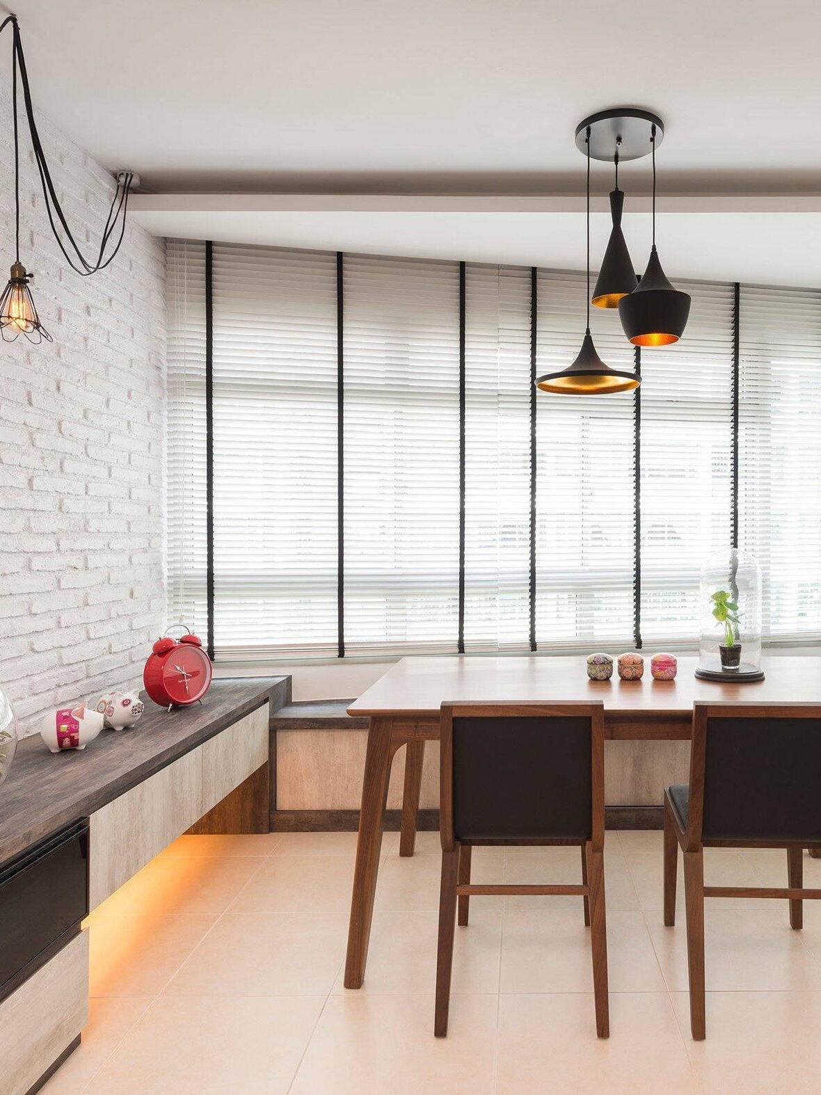 Mixed black pendants below a round canopy in a dining area