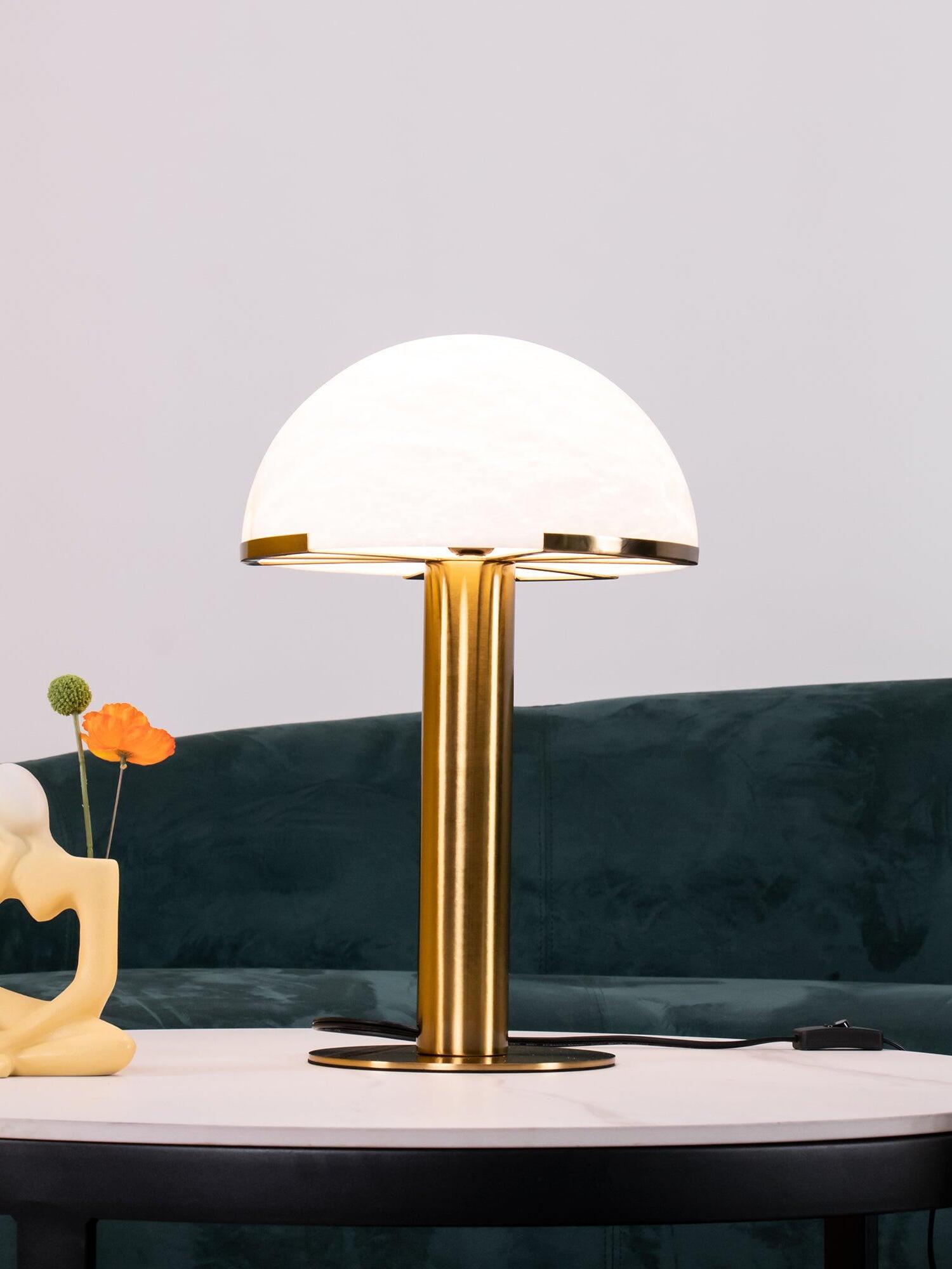 Pale textured dome lamp beside a green sofa