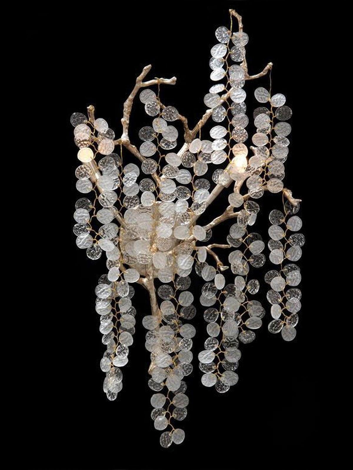 Clear disc strands and gold-toned branches on a dark background