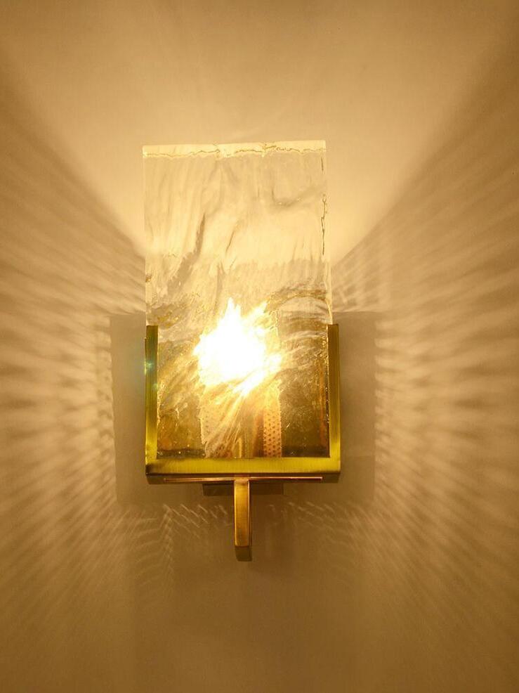 Warmly lit Crystal wall light and reflected pattern