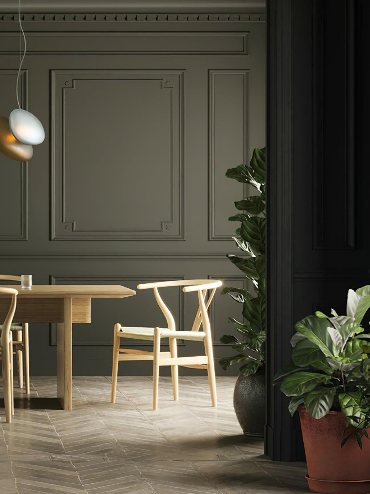 White and amber pebble pendant forms in a dining room