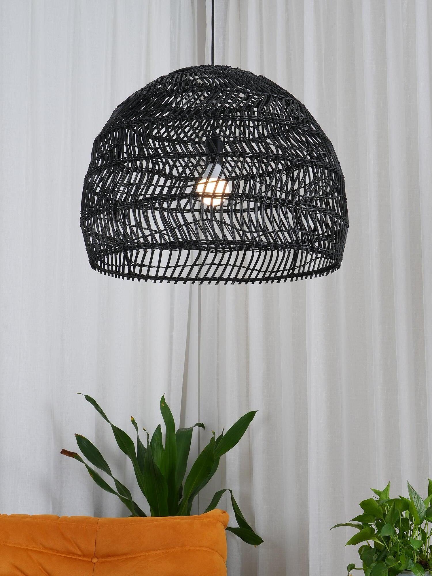 Black rounded rattan shade with a visible bulb