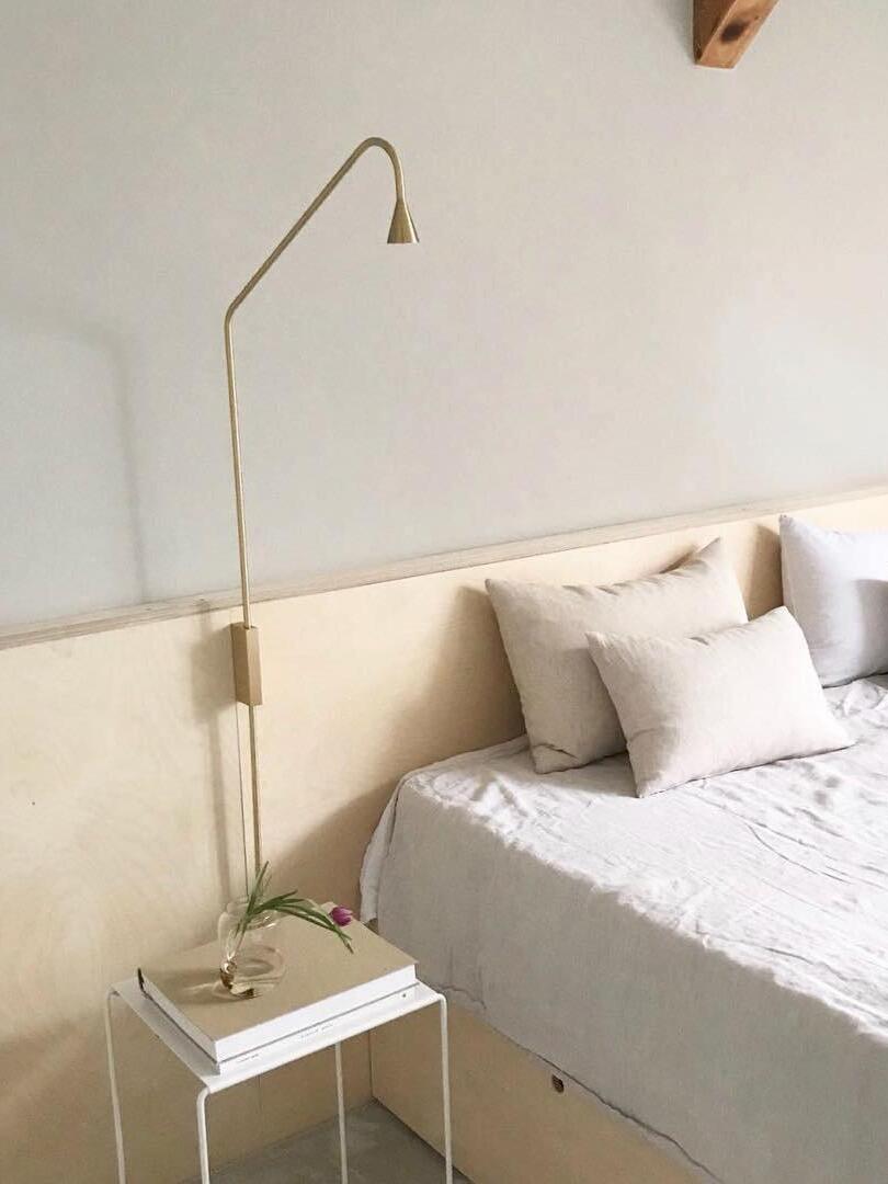 Golden Austere beside a bed and small table