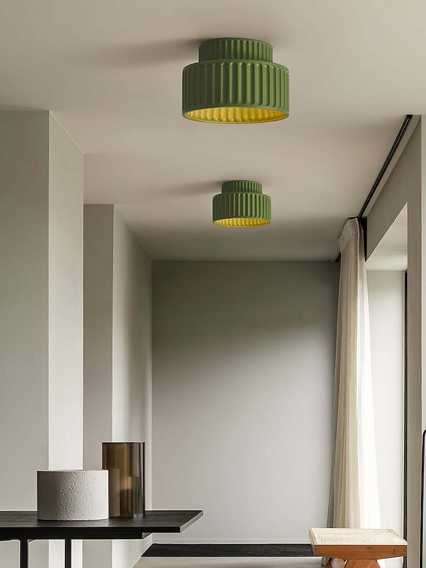 Two green ceiling lights mounted along hallway