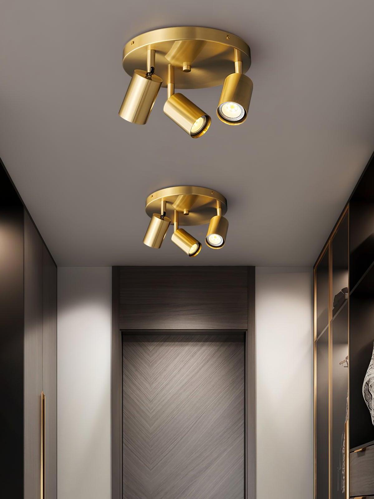 Two separate brass Hugo fixtures along hallway ceiling