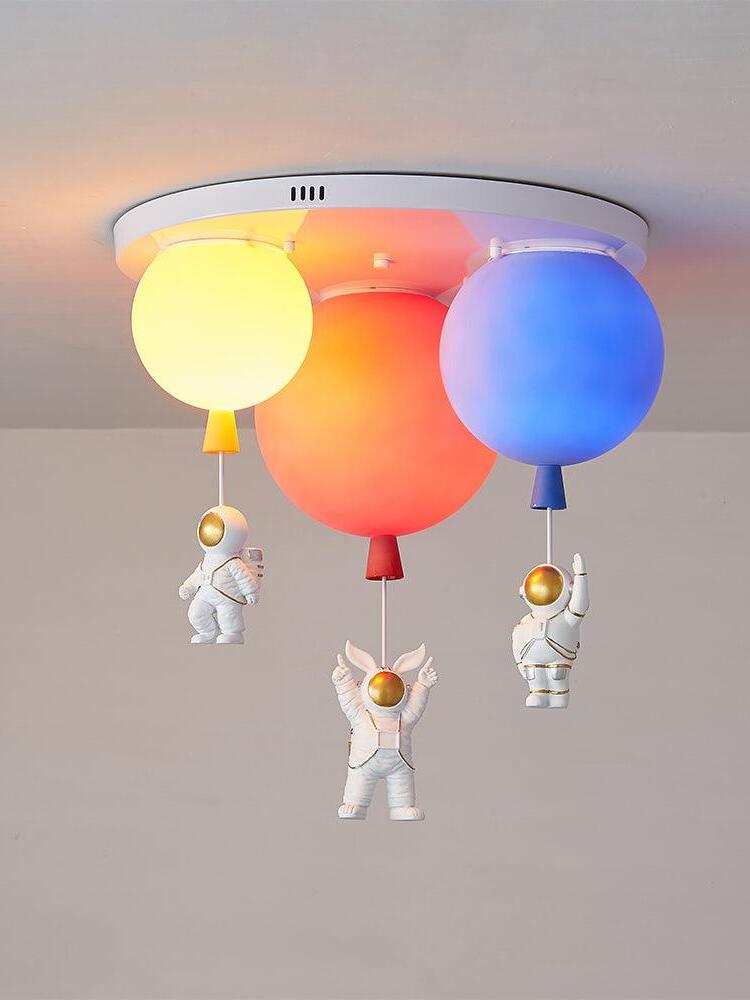 Orange red and blue three-balloon fixture illuminated