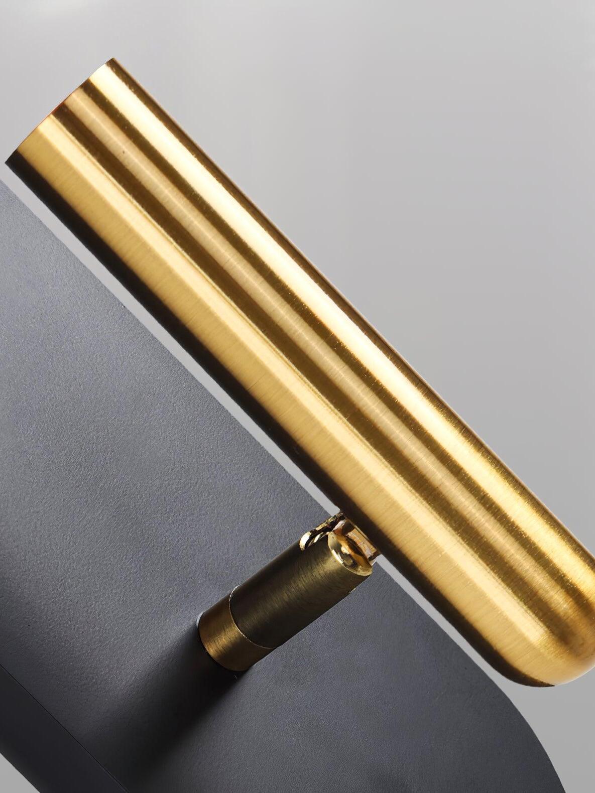 Close-up of the Nights gold-tone cylindrical head and pivot joint on a black backplate