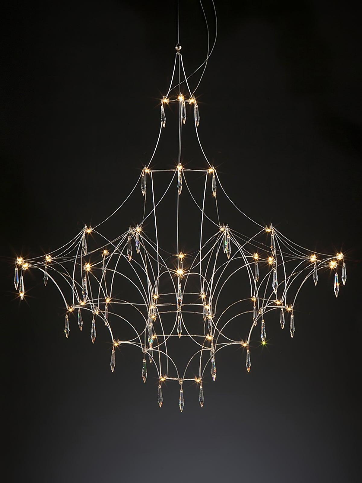 Illuminated Mira lattice chandelier with hanging crystal prisms against a dark background