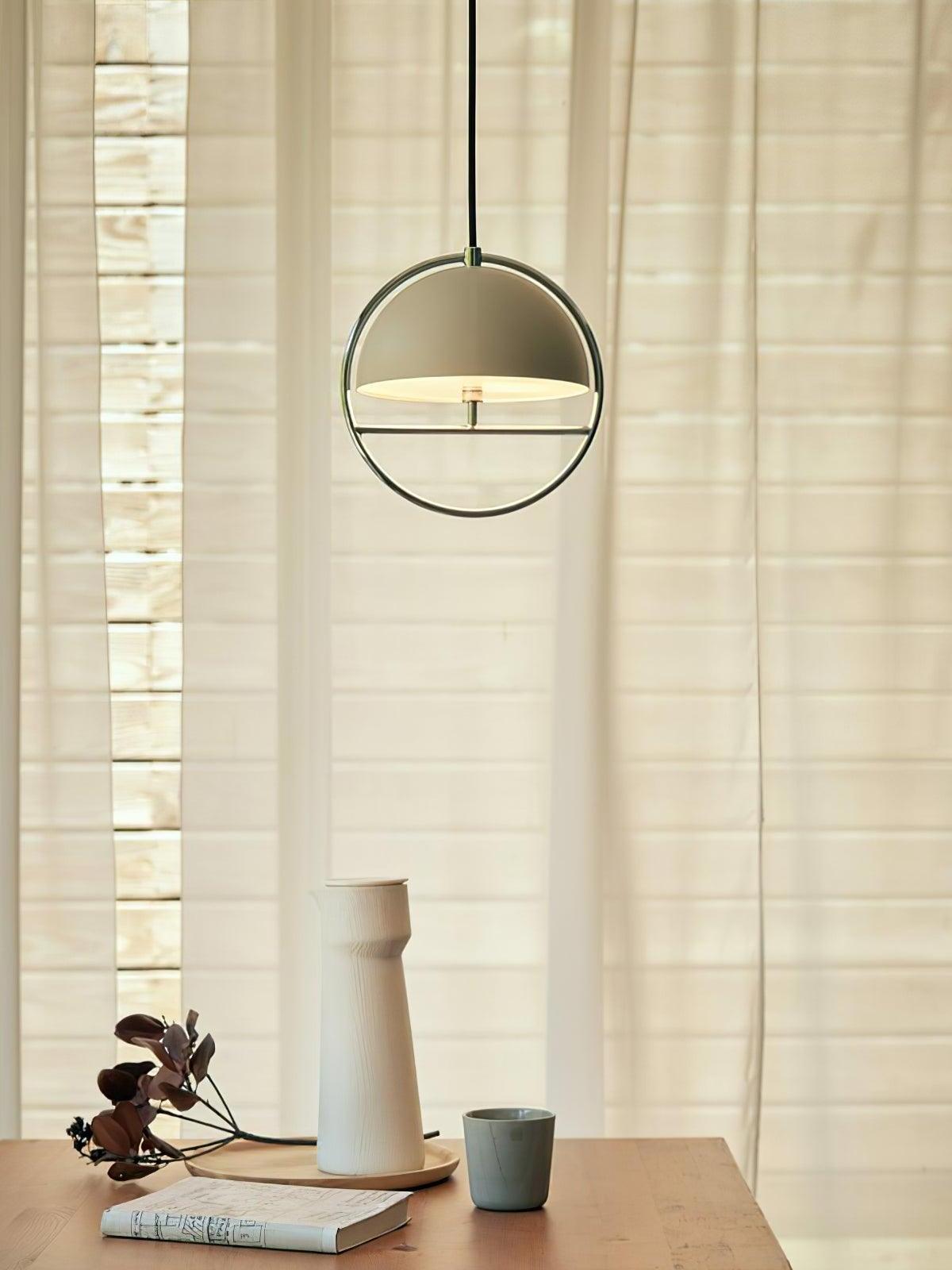 White circular pendant beside pale window curtain