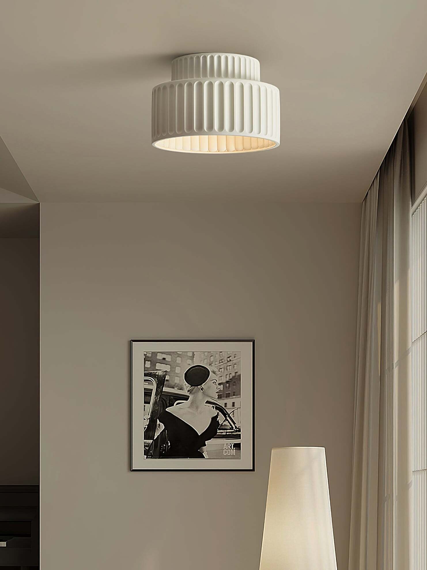 White ceiling lamp above wall print in room