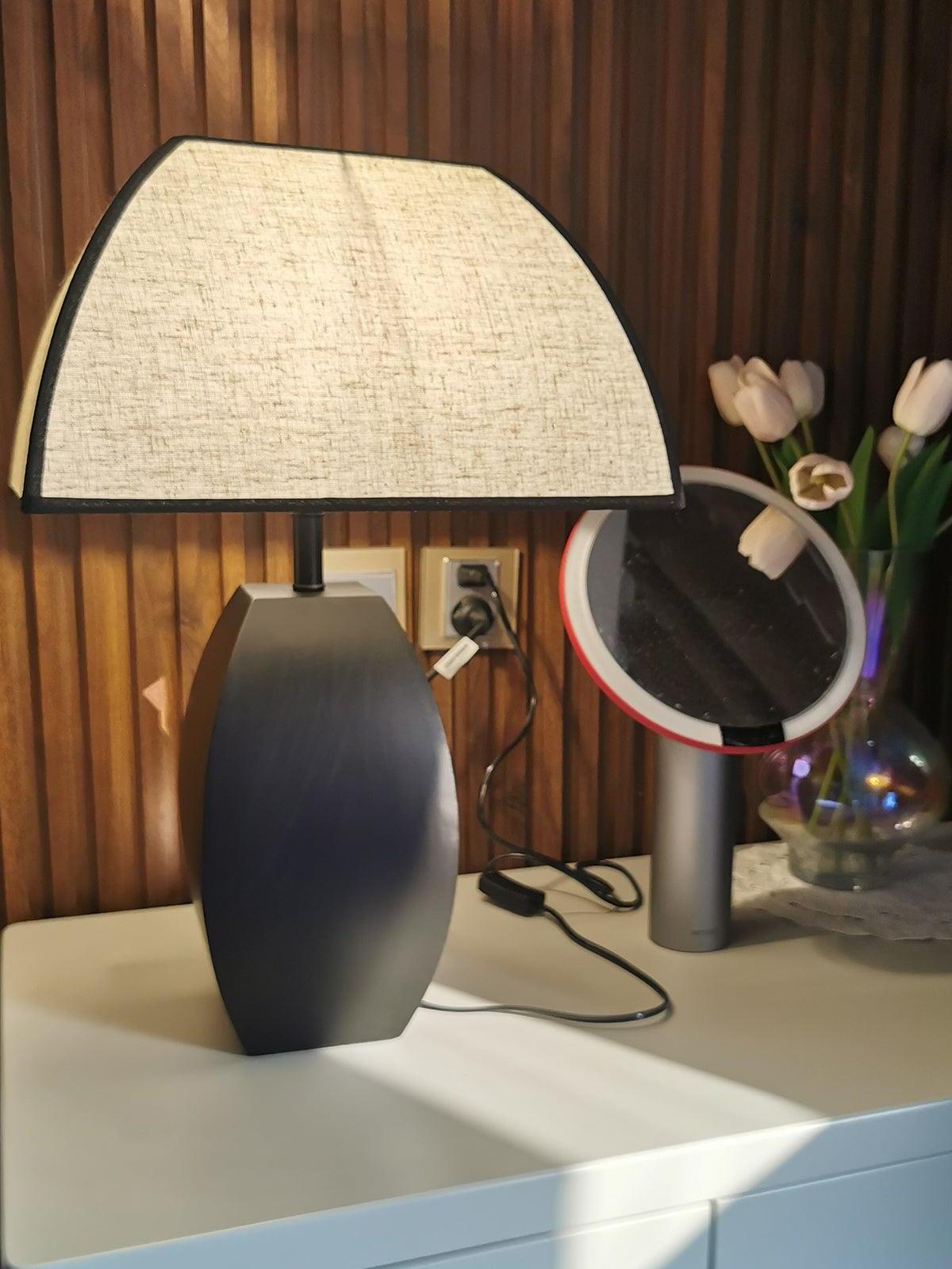 Lit Javier lamp against vertical wood wall