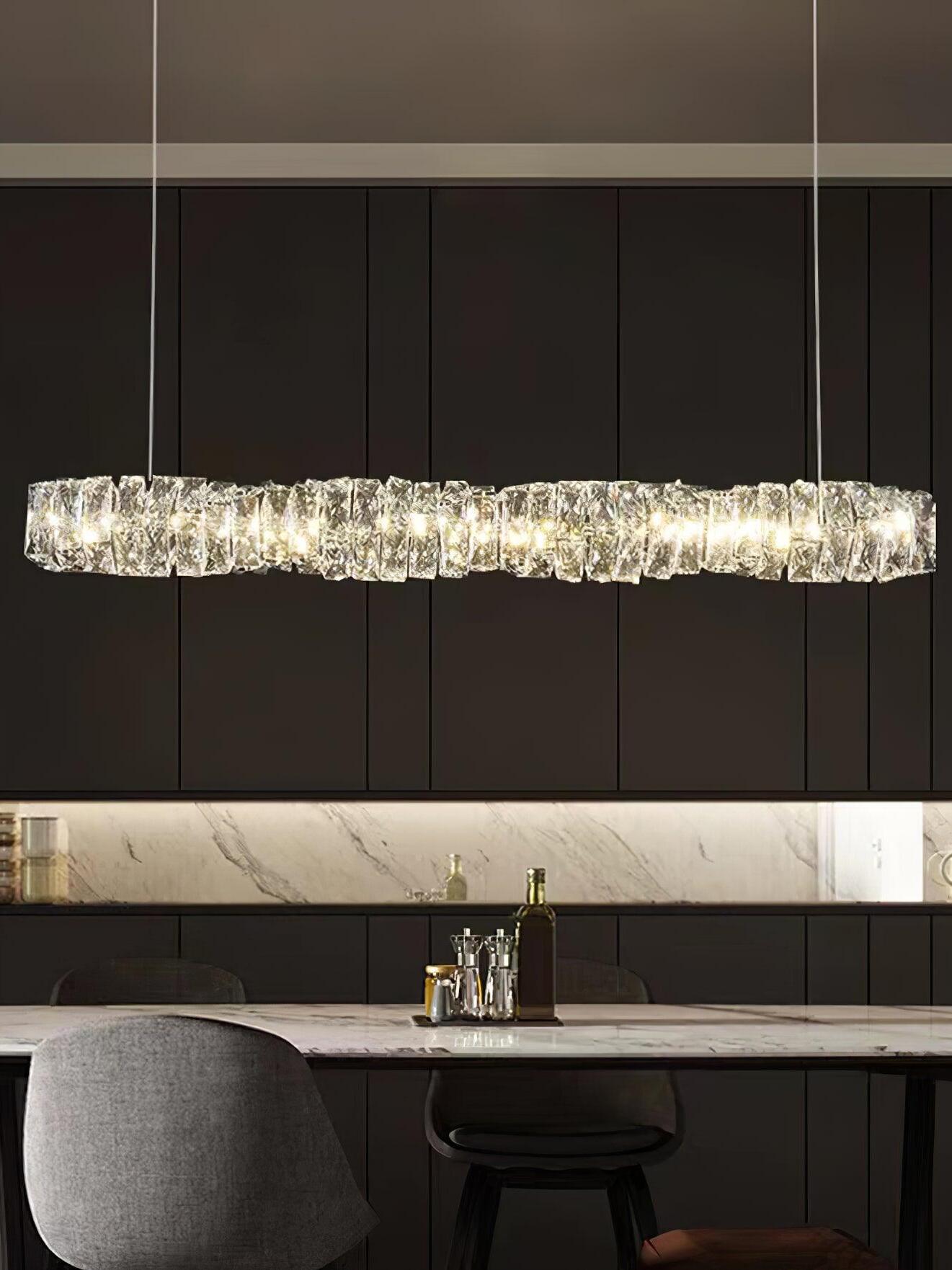 Front view of the crystal bar above a kitchen island with a black stool and dark cabinets