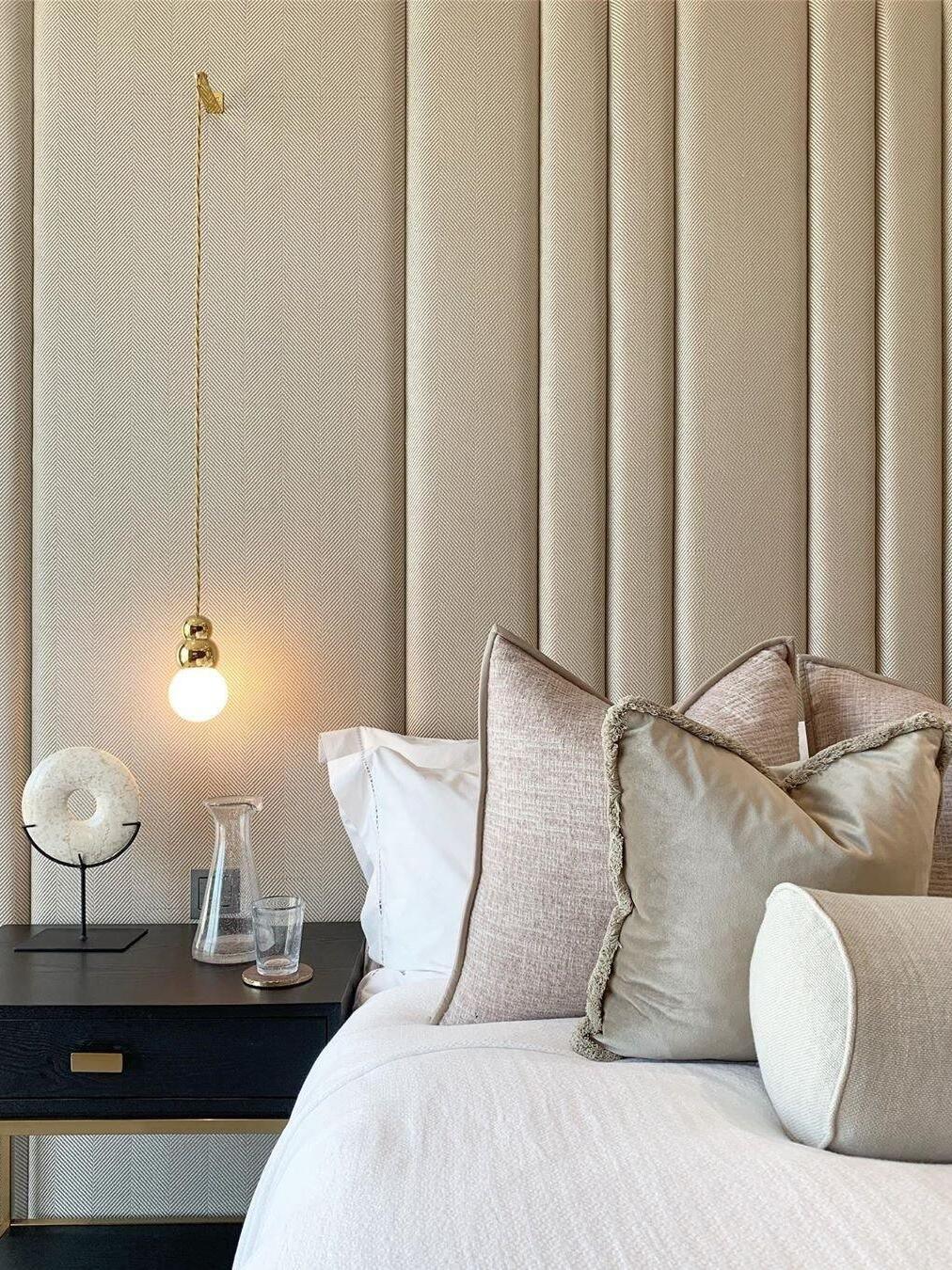 Gold Ball Light drop illuminating a bedside area