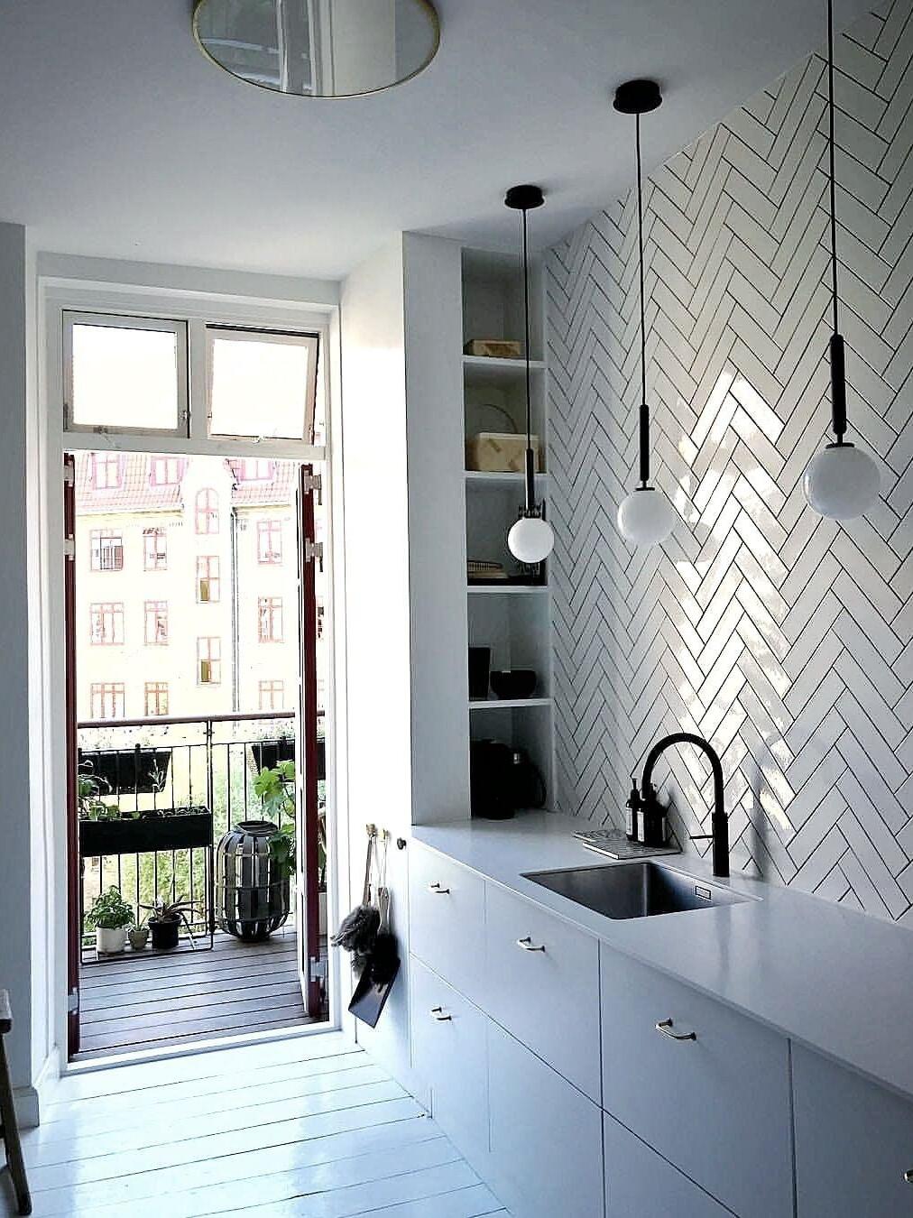 Globe pendants beside a kitchen window