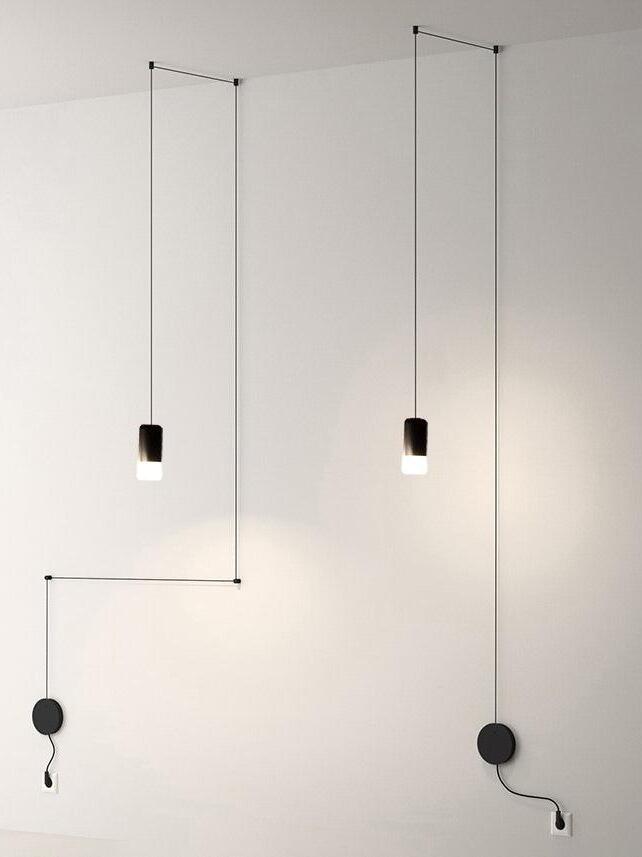 Two single-head black cable pendants with round wall plates and ceiling routing