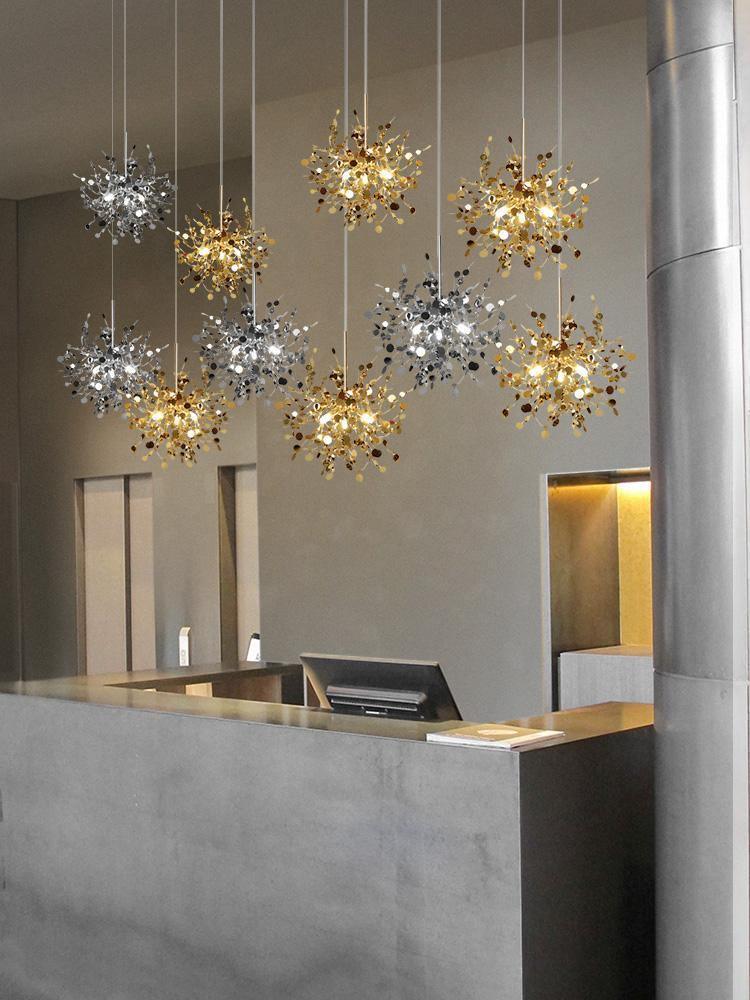 Separate silver and gold disc clusters hung at staggered heights