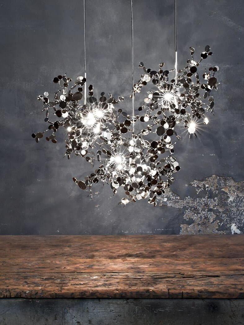 Three separate silver disc clusters above a wooden surface