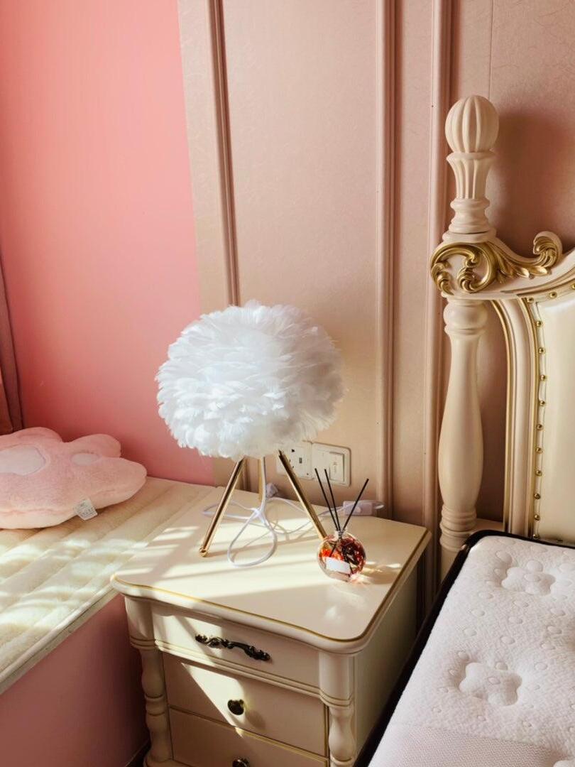 White feather lamp on cream nightstand
