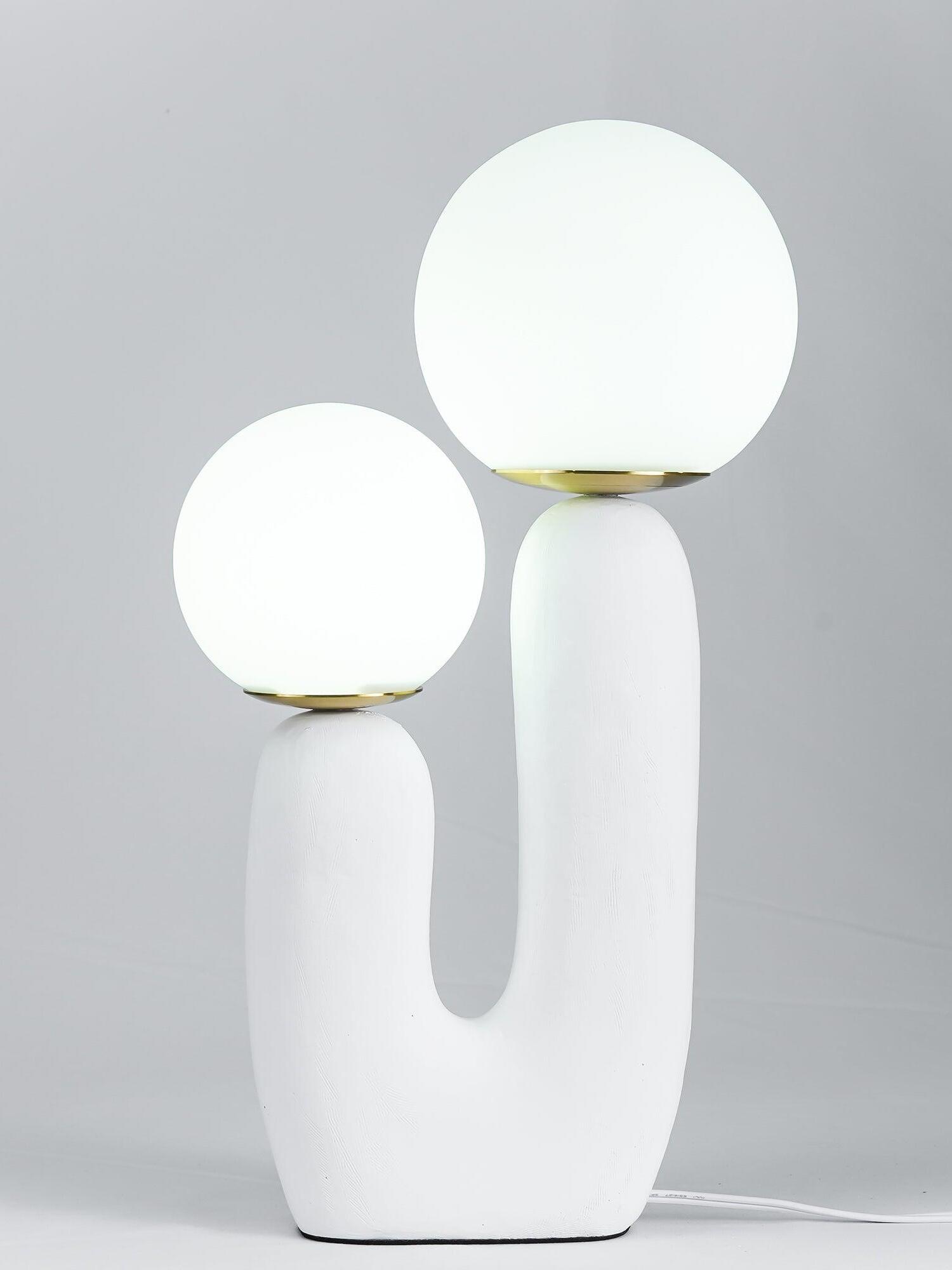 White Oo Rough lamp against grey with bright glowing globes, warm-metal collars and cord to right