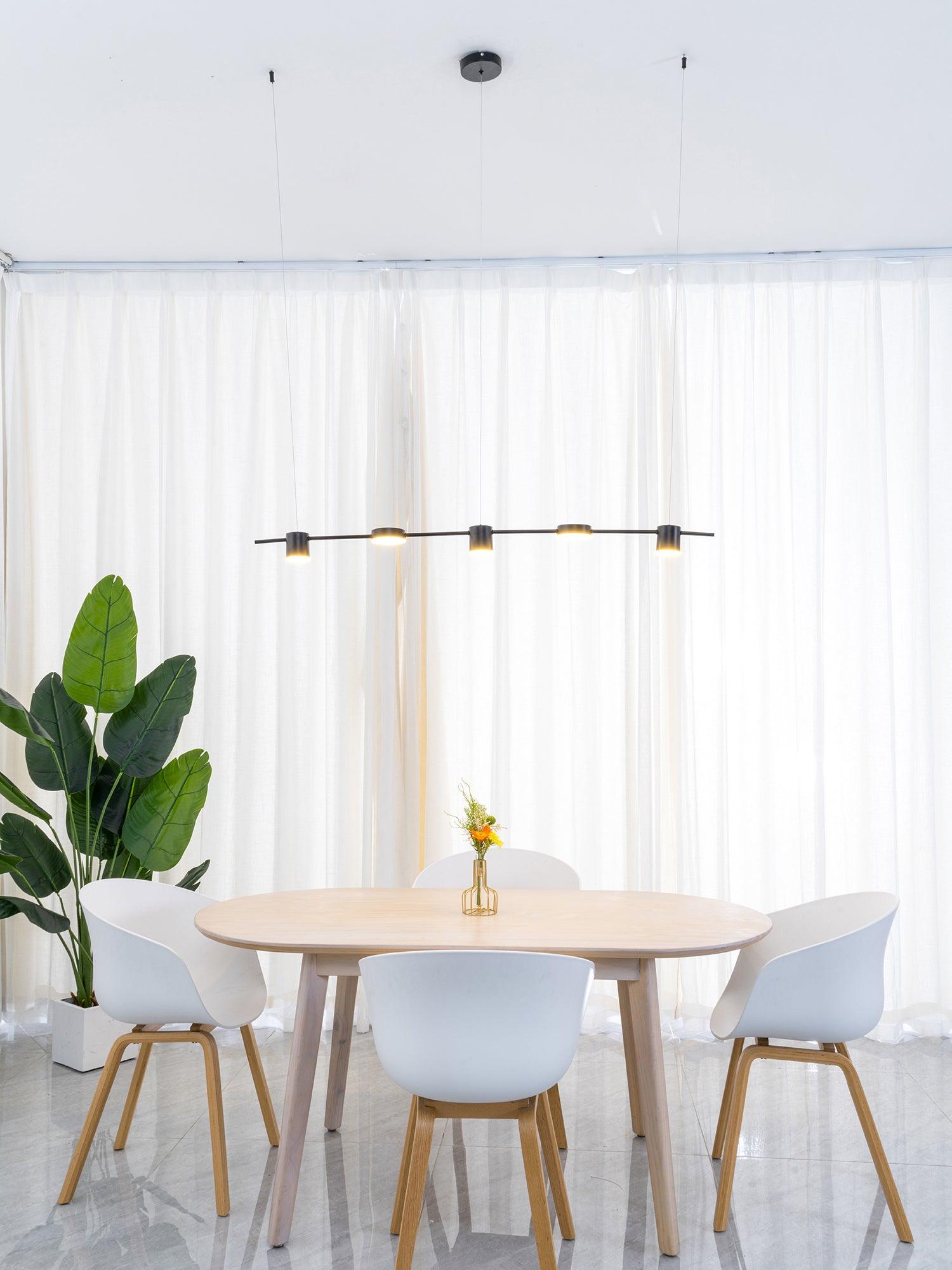 Gold linear LED light above a round wooden table