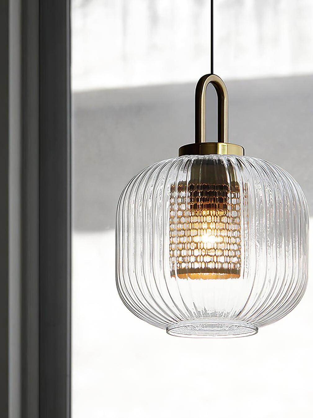 Gold-coloured loop and clear shade near a window