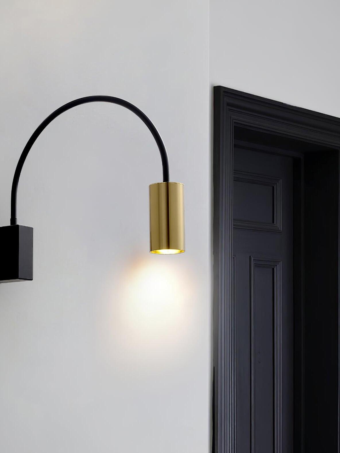 Black-and-gold Antonella lamp beside a dark doorway