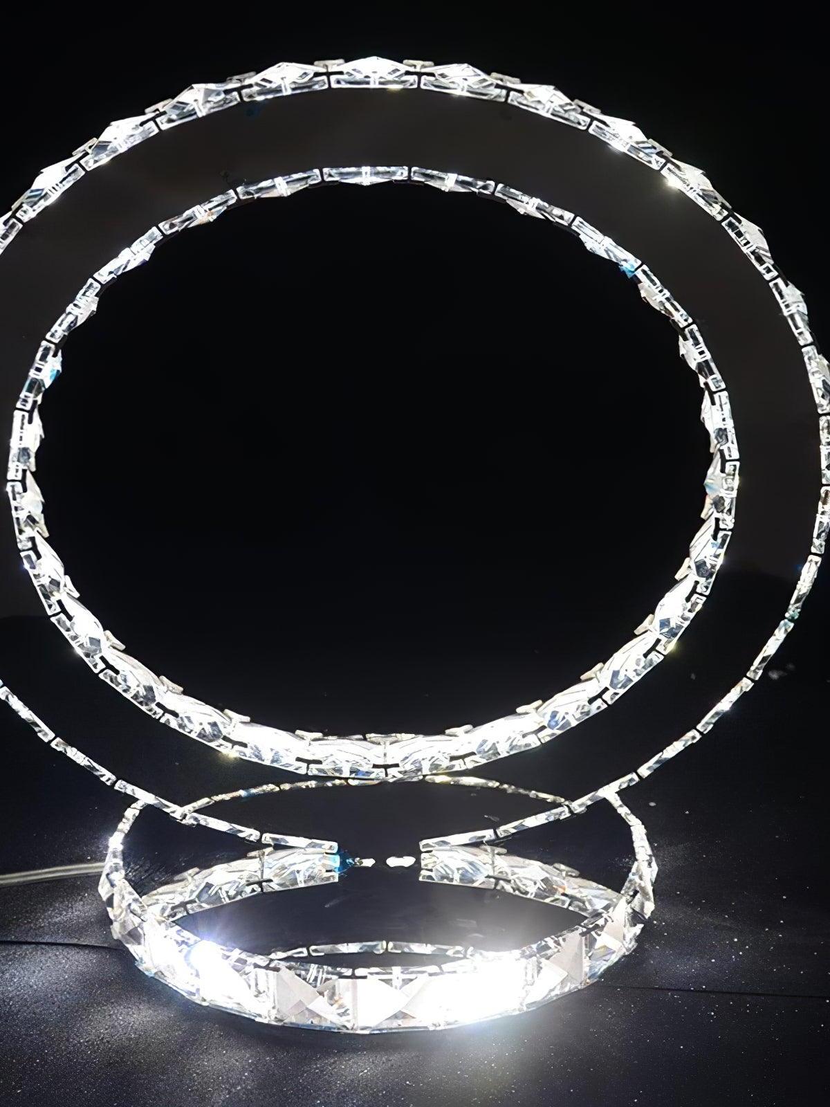 Oblique view of the illuminated ring and reflective circular base against a dark background