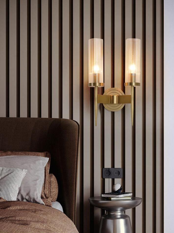 Twin glass sconce beside a bed and slatted wall