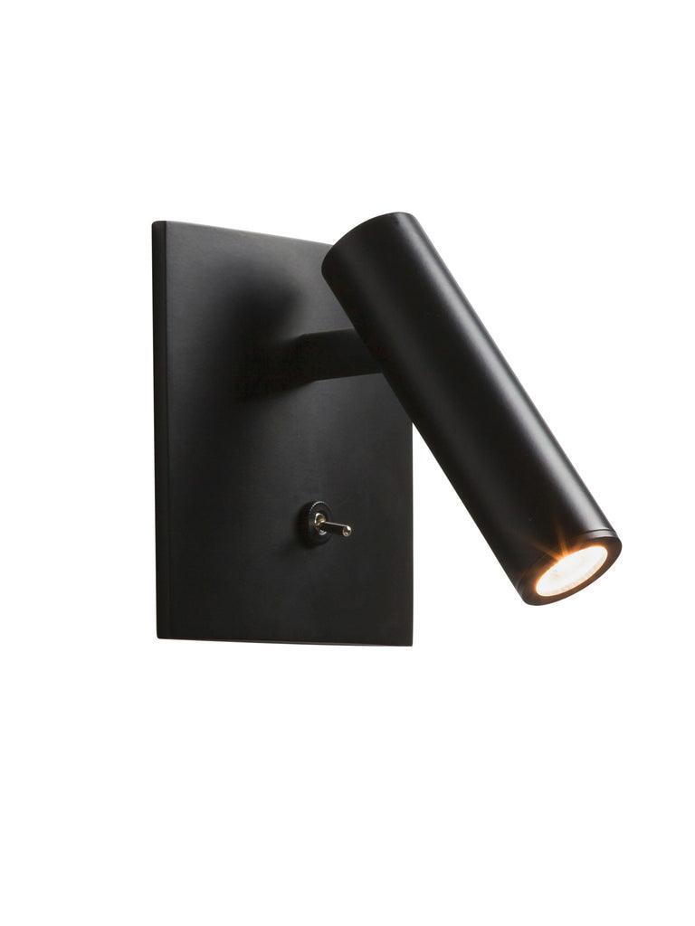 Black Enna wall light with angled lit cylindrical head, square plate, short stem and lower toggle isolated on white