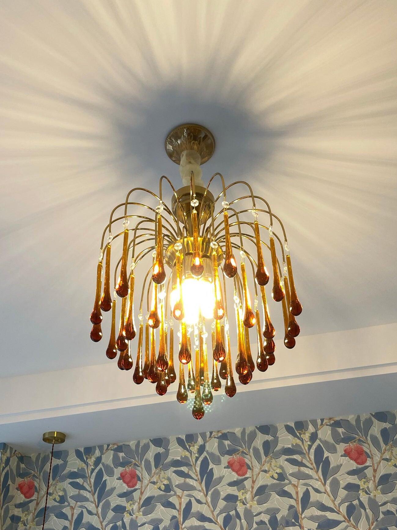 Small chandelier casting patterned light on a ceiling
