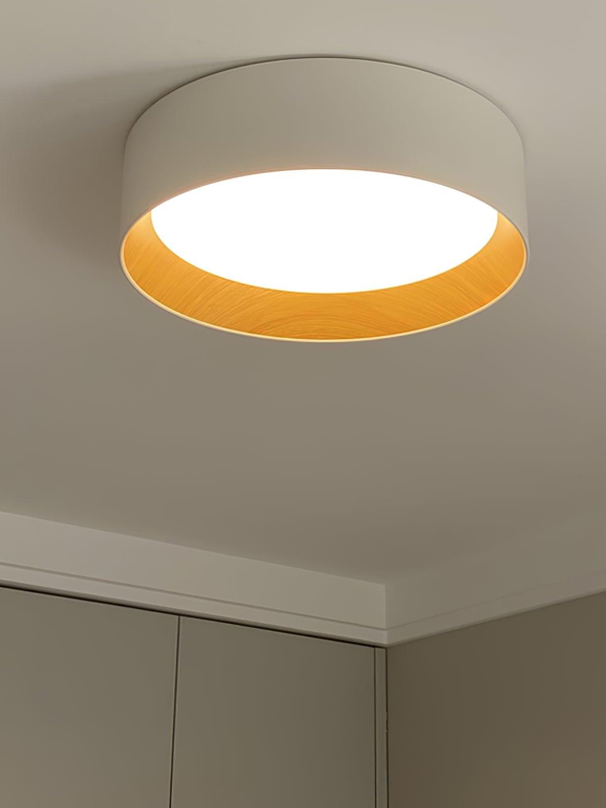 Light-coloured round fixture with warm inner rim