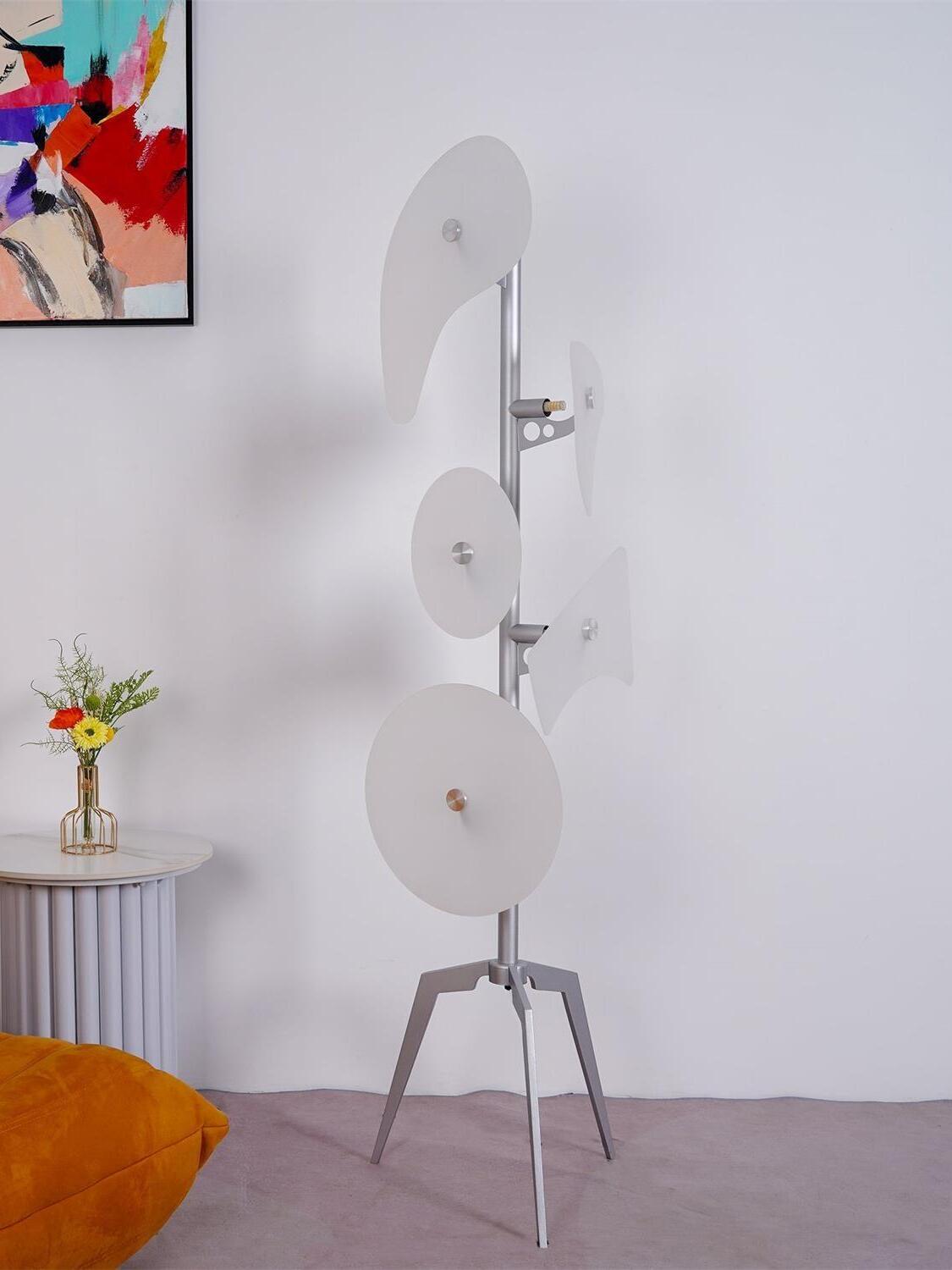 Unlit white panel lamp beside colourful artwork