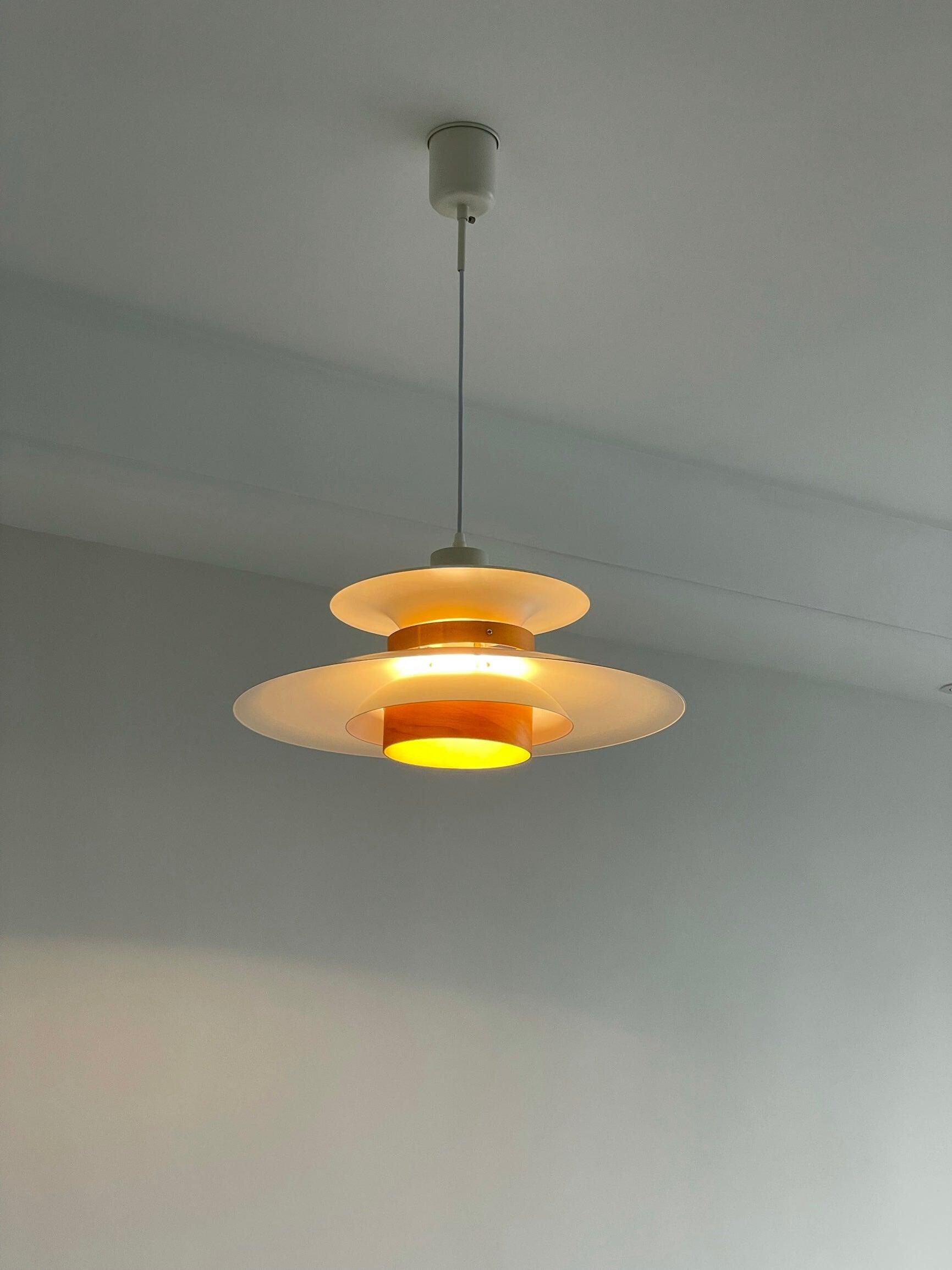 Pendant with glowing light between stacked shades
