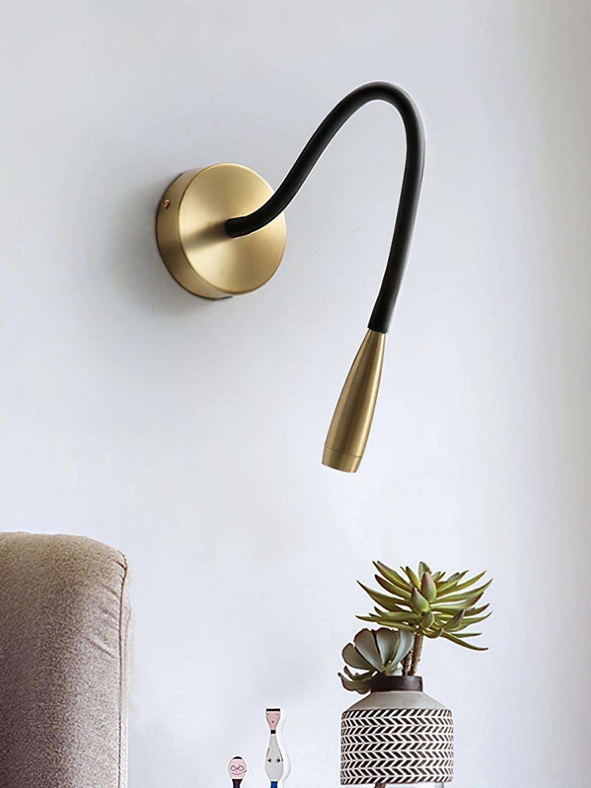 Gold Flexi with curved dark arm above an armchair edge and a succulent in a patterned vase