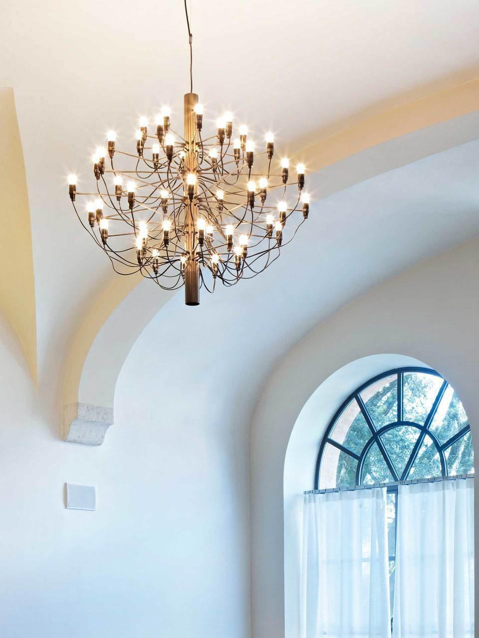 Large chandelier beside an arched window