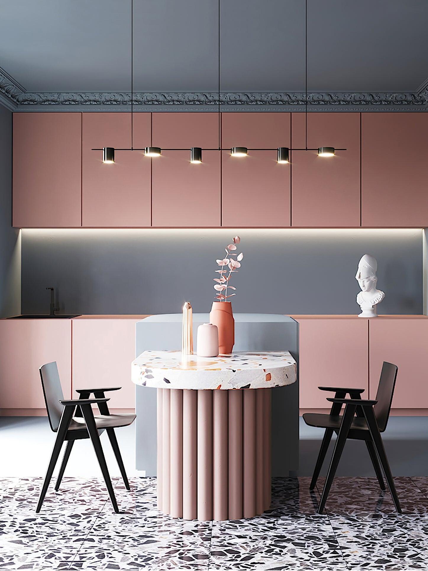 Linear light over a dining table against pink cabinets