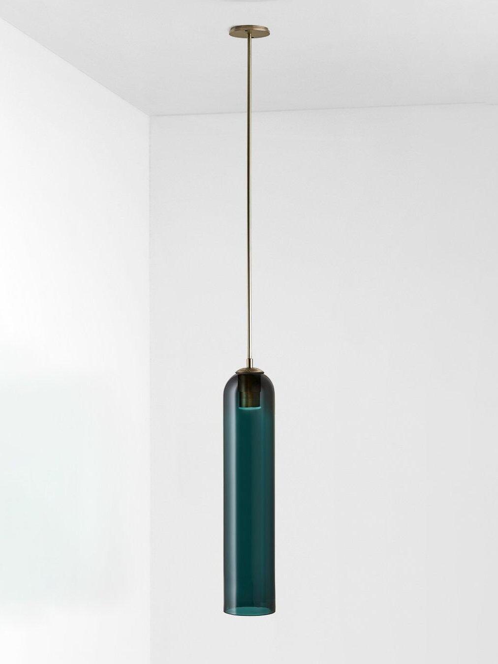 Blue glass Long Tube pendant with gold-toned straight rod, round ceiling canopy and socket visible through the upper shade
