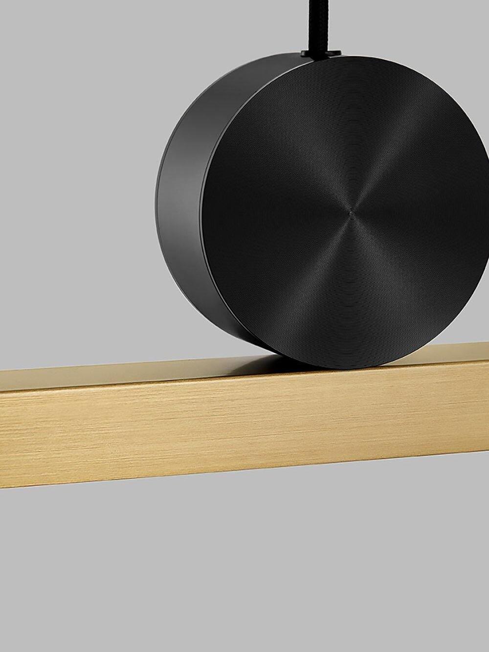 Close view of Black circular disc on Gold-toned bar