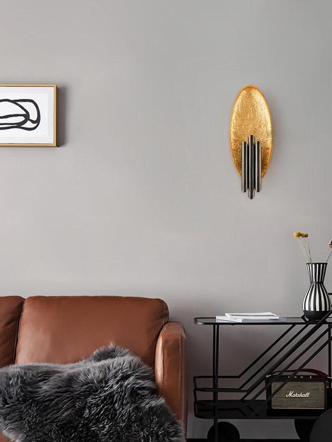 Gold-tone oval and dark tubes above brown upholstered seating