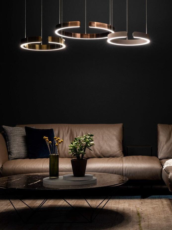Several suspended rings above a dark sofa