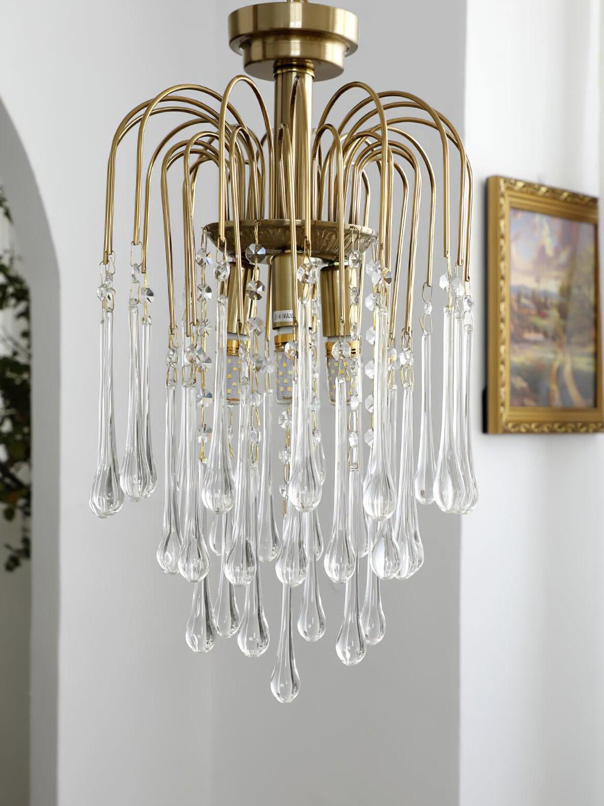 Clear chandelier near a framed picture