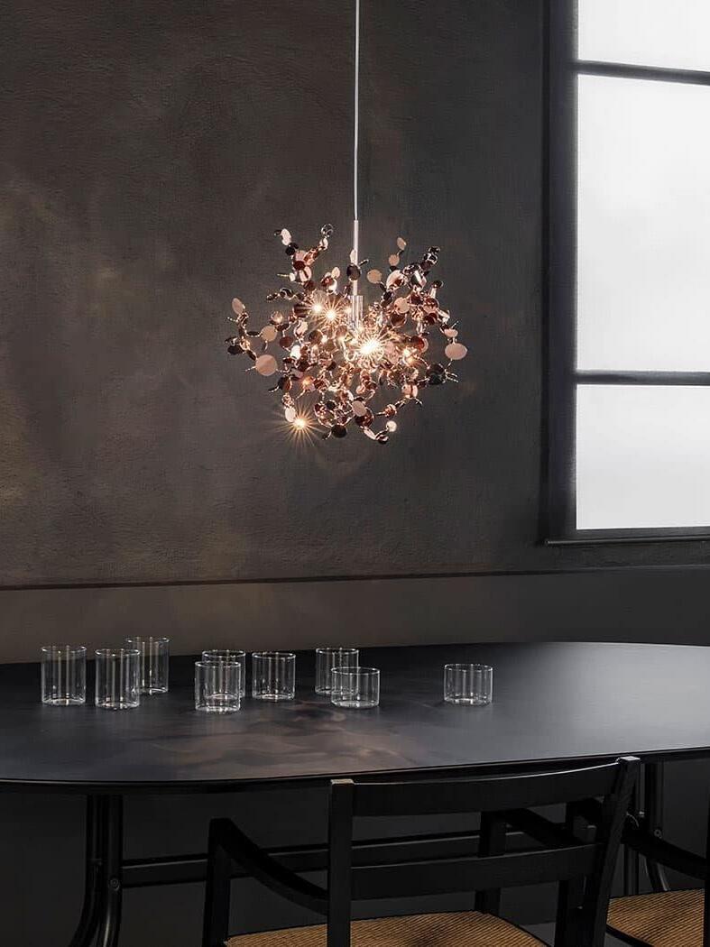 Single warm disc cluster above black dining chairs