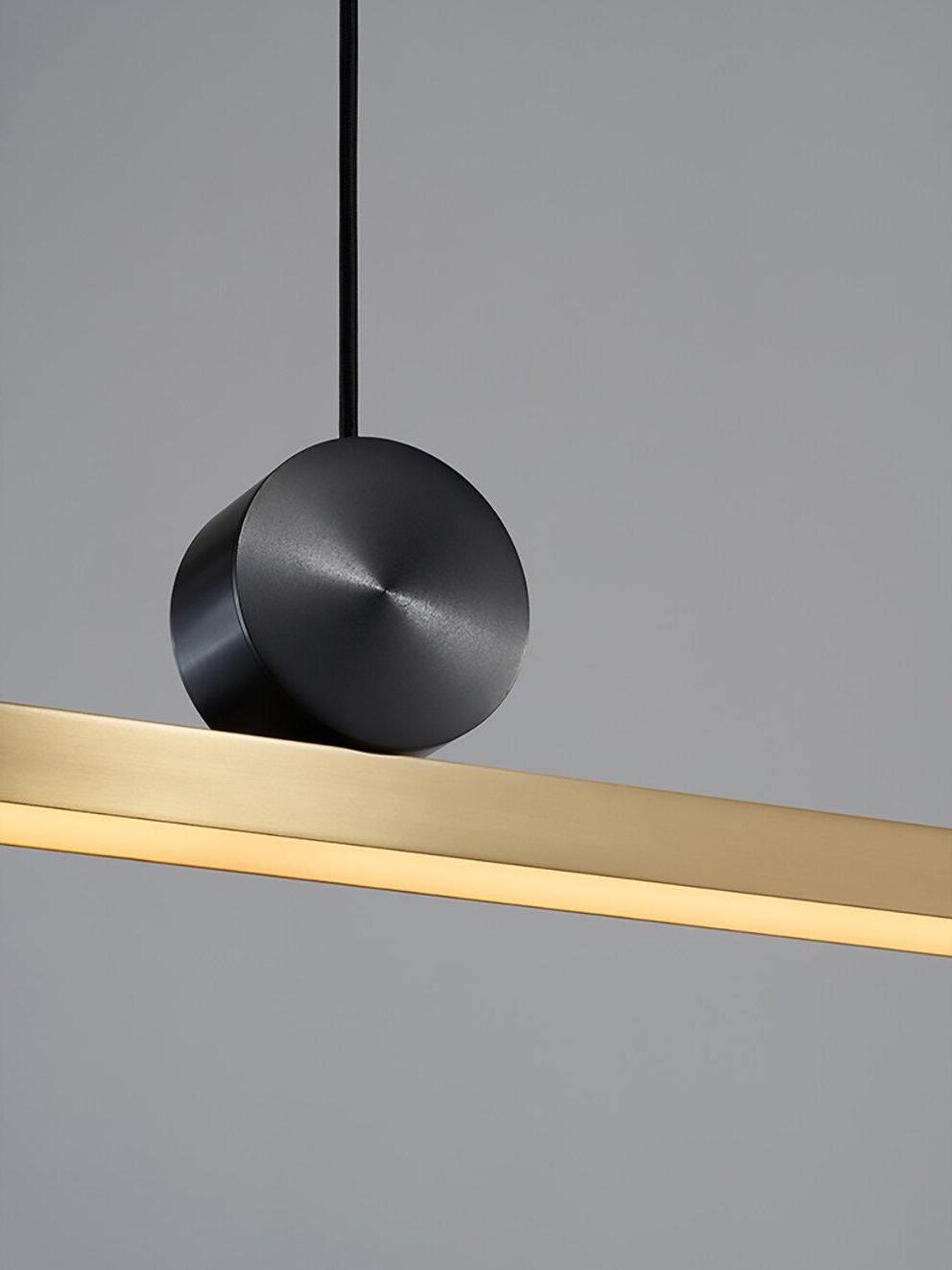 Black disc and illuminated edge of Gold-toned bar