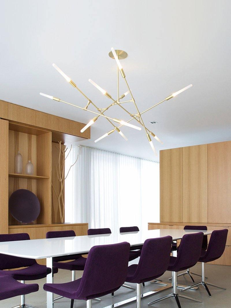 Gold branches above a table with purple chairs