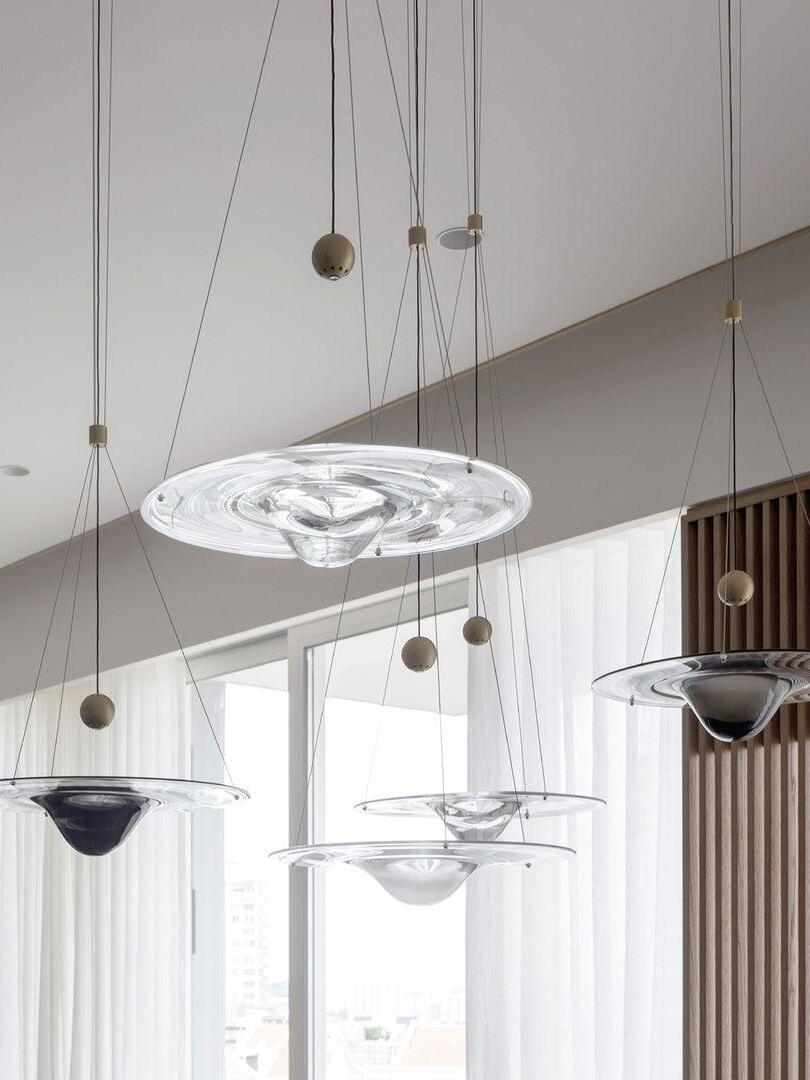 Transparent disc pendants hanging in bright room