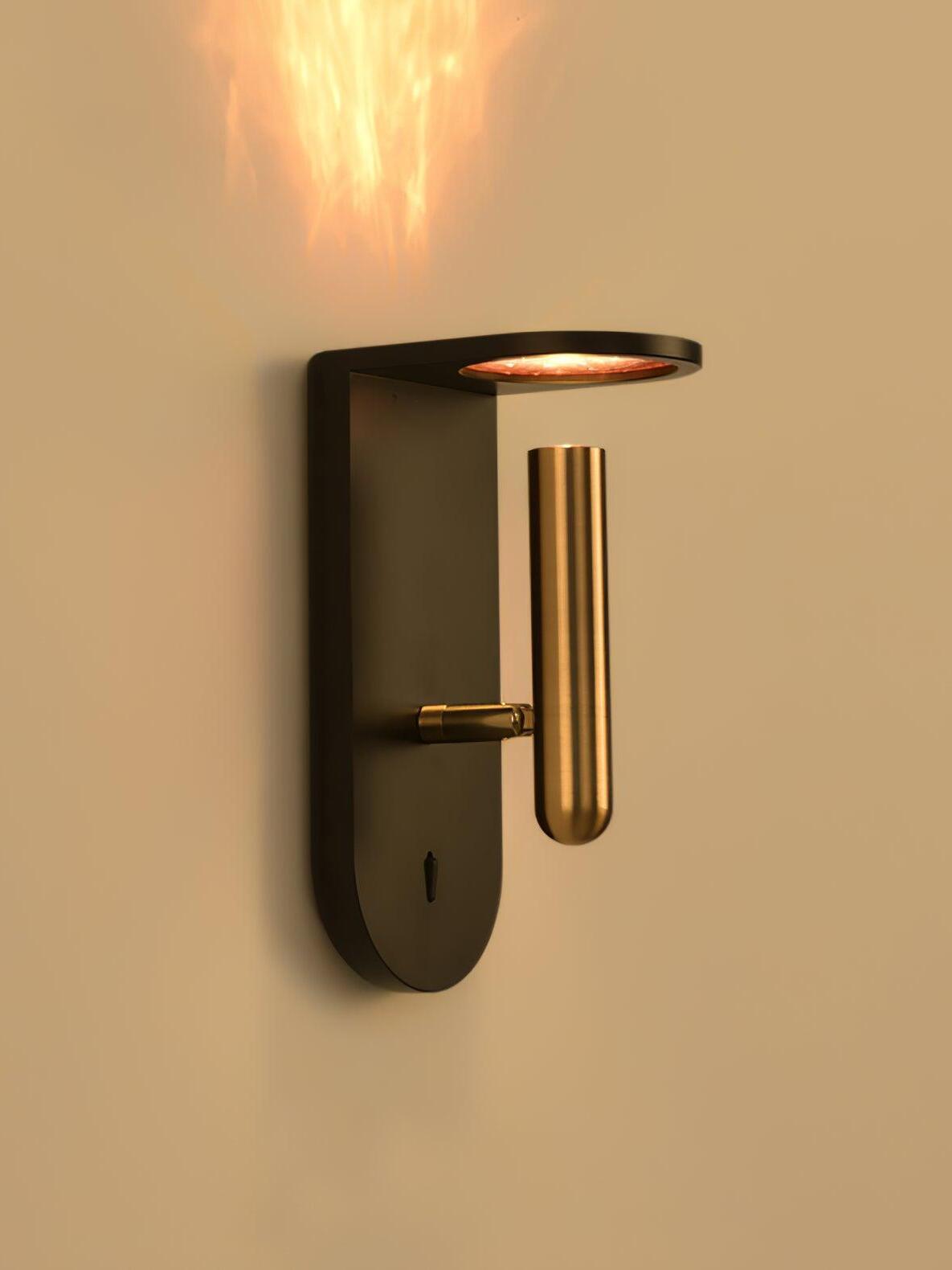 Angled black Nights wall light with a gold-tone cylindrical head and patterned light above it