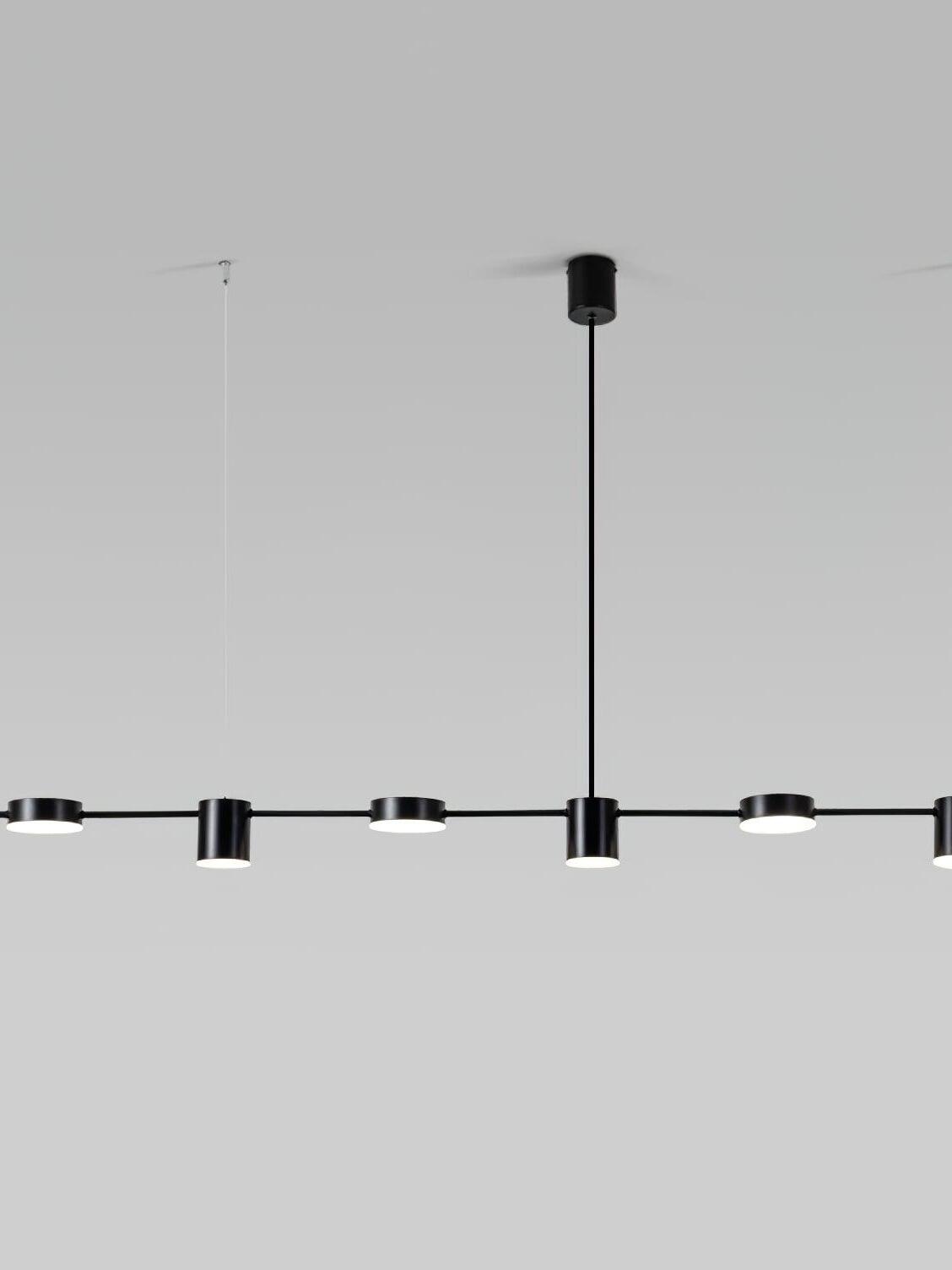 150 cm black disc-and-cylinder pendant suspended from fine wires