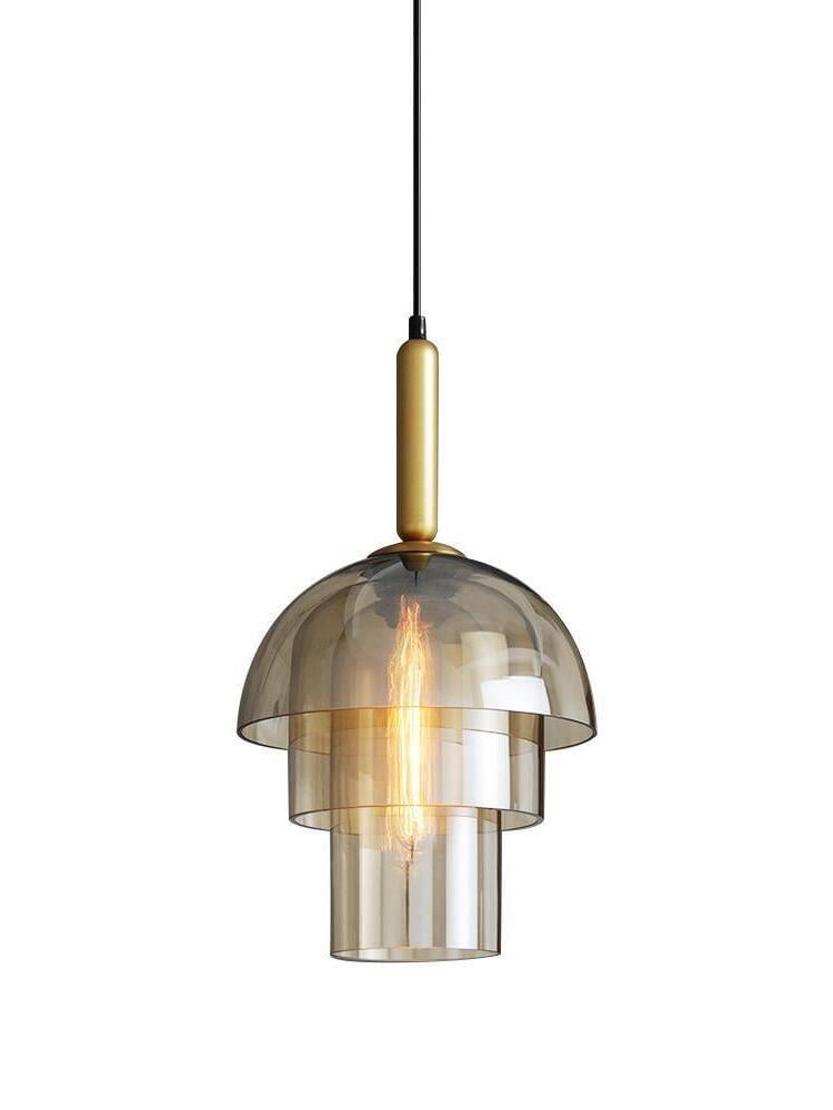 Three-tier amber glass pendant isolated on white, with two narrower lower cylinders, gold-tone fitting and black cable