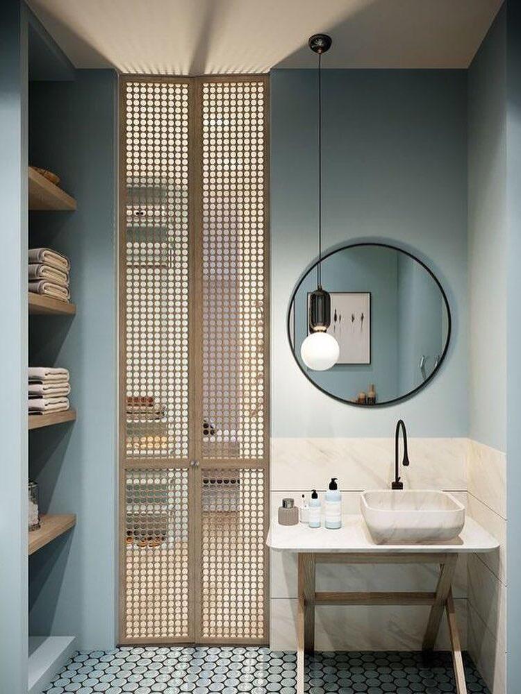 Black-cap globe beside a round mirror in a bathroom scene