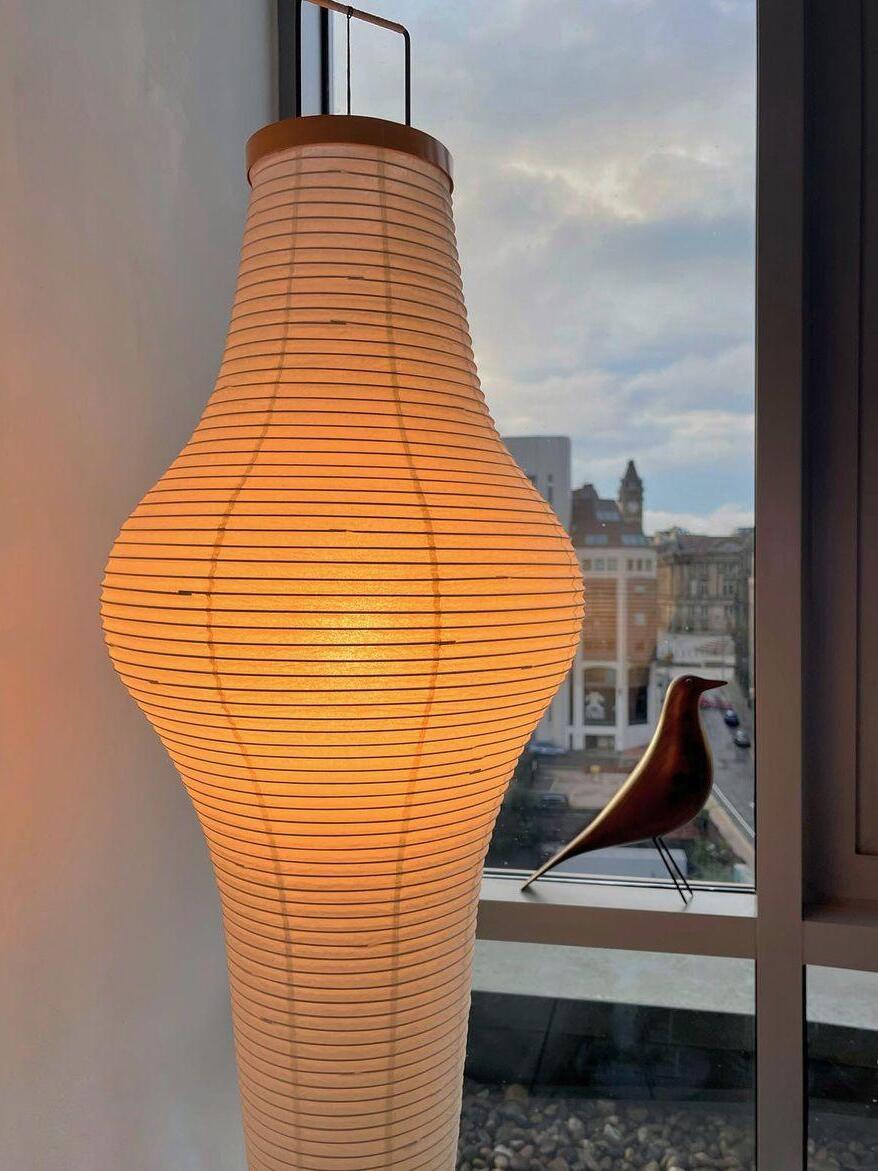 Tall ribbed paper shade close-up near a window